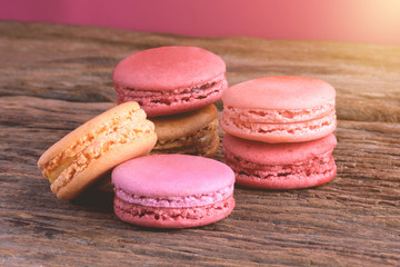 Different types color of macaroons on Old grunge wooden background