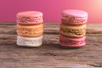 Different types color of macaroons on Old grunge wooden background