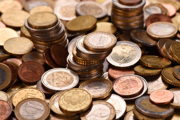 Euro coins scattered on the table. Good earnings. Financial flows.