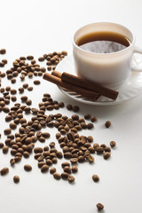 White Cup with Coffee, Coffee Beans on a White Background