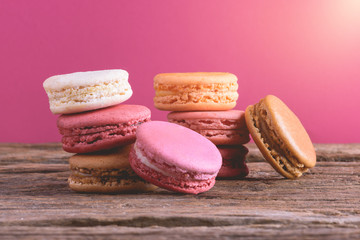 Different types color of macaroons on Old grunge wooden background