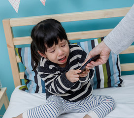 Her mother hold the phone with a crying child. Do not use the smartphone
