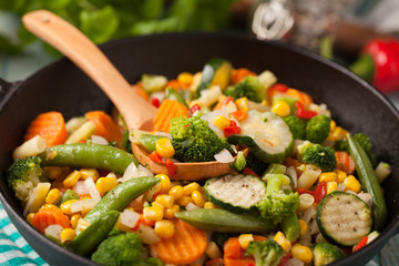 Mix of vegetables fried in a wok.