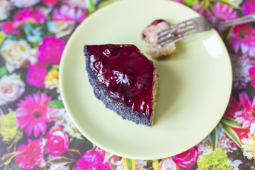 A piece of poppy cherry cake on a plate.
