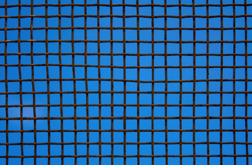 Photo of steel mesh wall on sky background