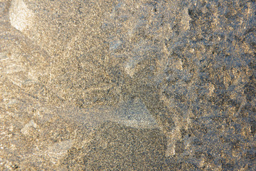 Frosty windows at sunset, close-up. Gold with silver. Stunning frosty background, frost artist.