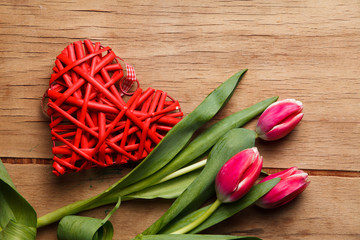 Red tulip on wood desk