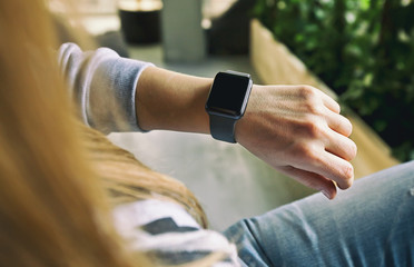 The modern smart watch on the woman's hand