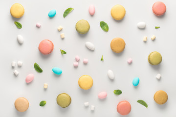 flat lay of colorful macarons cookies and candies like background, pastel colors