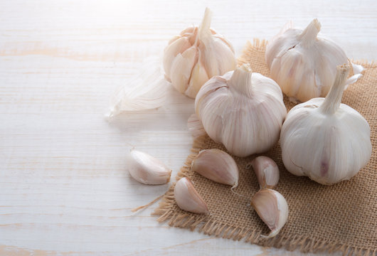 Garlic on white wooden table