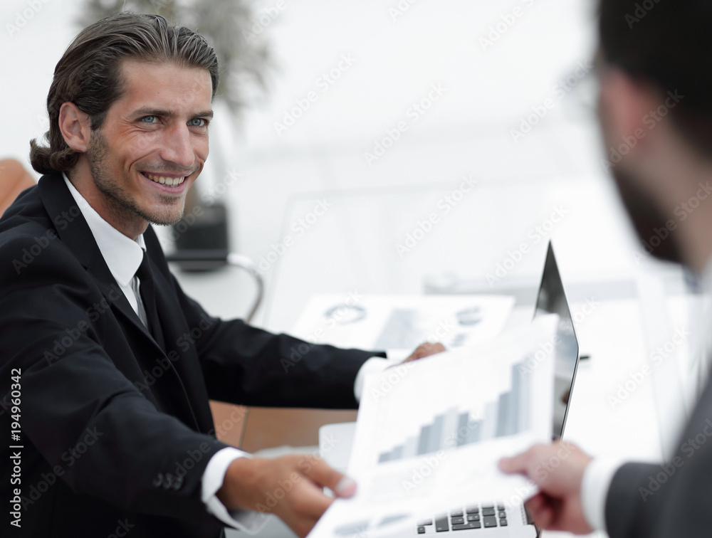 Poster employee gives the manager the financial report