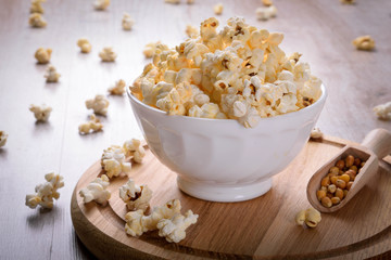 Salt popcorn on the wooden table, selective focus
