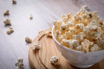 Salt popcorn on the wooden table, selective focus