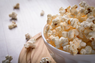 Salt popcorn on the wooden table, selective focus