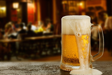 Mug with beer on the background of a outside bar.