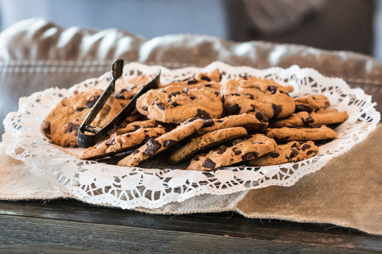 Plate Of Chocolate Chip Cookies With Plastic Tong - Side View