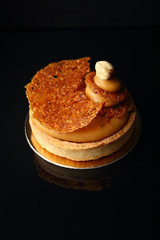 caramel tart on black background