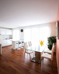 Dining room with glass table and leather chairs