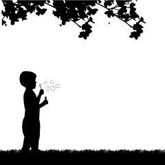 Boy blowing soap bubbles in park in spring silhouette, one in the series of similar images