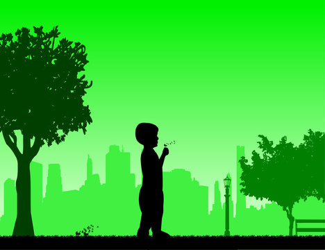 Boy blowing the dandelion in park under the tree silhouette, one in the series of similar images