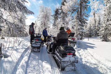 Athletes on a snowmobile