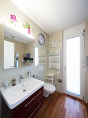 Tap in bathroom with large tiles