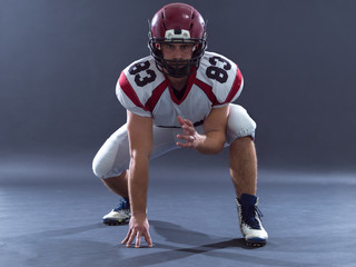 American football player getting ready before starting