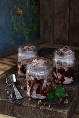 Homemade Organic Coffee Ice Cream with Black Chocolate and Mint in Jar on wooden background. Copy space