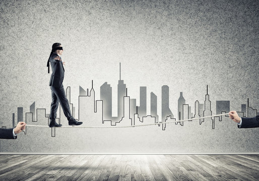 Business concept of risk support and assistance with man balancing on rope