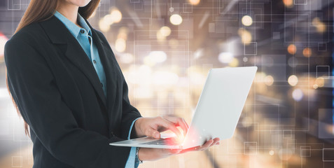 Business woman hands holding and using laptop on futuristic technology connection shape over the motion interior space background.Concept of business people use technology.