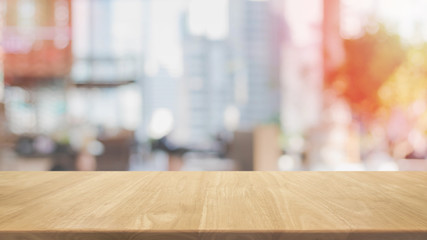 Empty wood table top and blurred restaurant interior background - can used for display or montage your products.