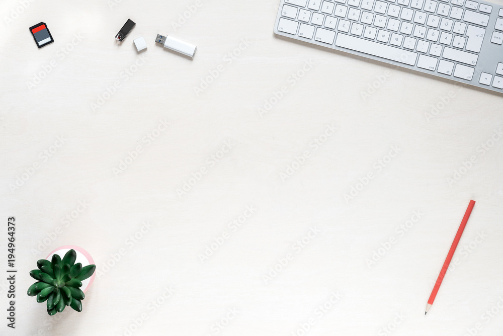 Wall mural copy space on white desk background with keyboard, usb sticks and sd memory card
