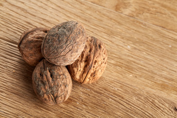 A stack of walnuts piled together and isolated on dark background, shallow depth of field, selective focus