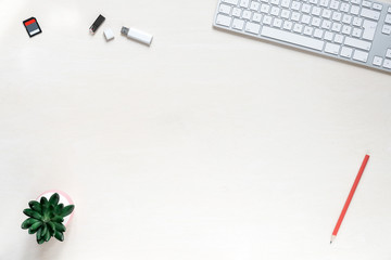 Copy space on white desk background with keyboard, usb sticks and sd memory card