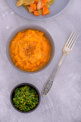 Mashed sweet in plate with steamed vegetables