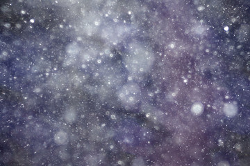 Snowfall texture of snowflakes on blurred background