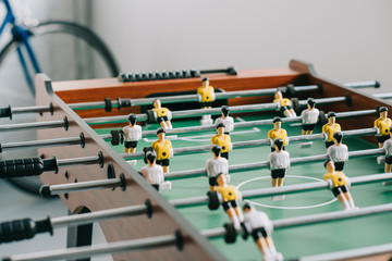 table soccer and bicycle in living room