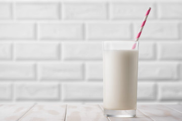 Glass of milk on a white table