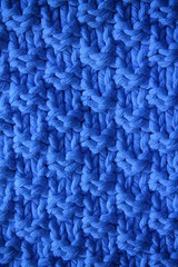 Blue texture of a knitted woolen fabric blue. Background for web site or mobile devices.