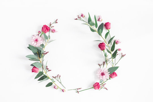 Flowers composition. Wreath made of various pink flowers and eucalyptus branches on white background. Flat lay, top view, copy space