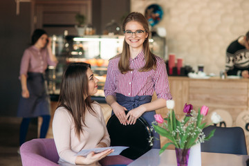 Waitress taking order from her customer in a cafe