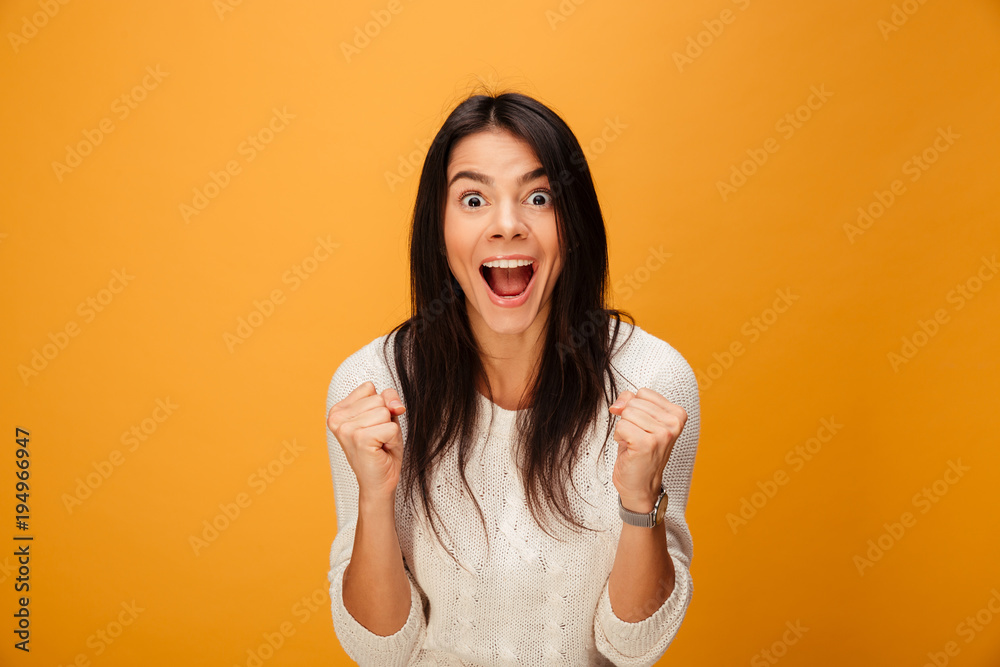 Wall mural Portrait of a happy young woman celebrating