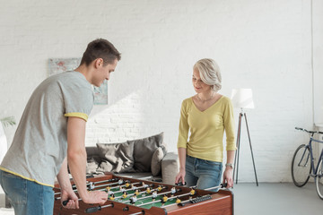 couple playing table soccer at home