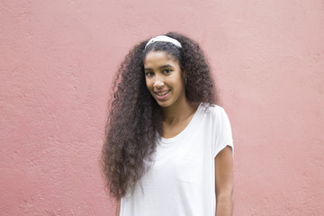 portrait of african american girl on the pink wall