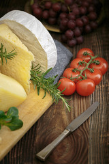Cheeses with basil, rosemary, tomatoes and grapes.