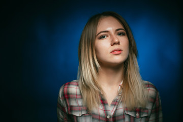 Fototapeta premium portrait smiling girl on blue background in studio