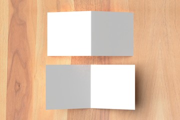 Bifold square brochure mock up on wooden background. 3D illustrating.