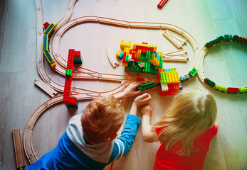 kids playing with toy railroad and trains