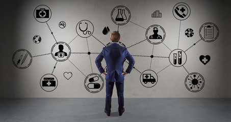Businessman watching medical interface on a wall 3D rendering