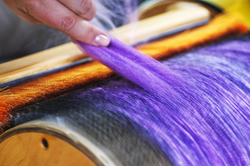 Felting wool. The step of combing the material in a special carding machine.